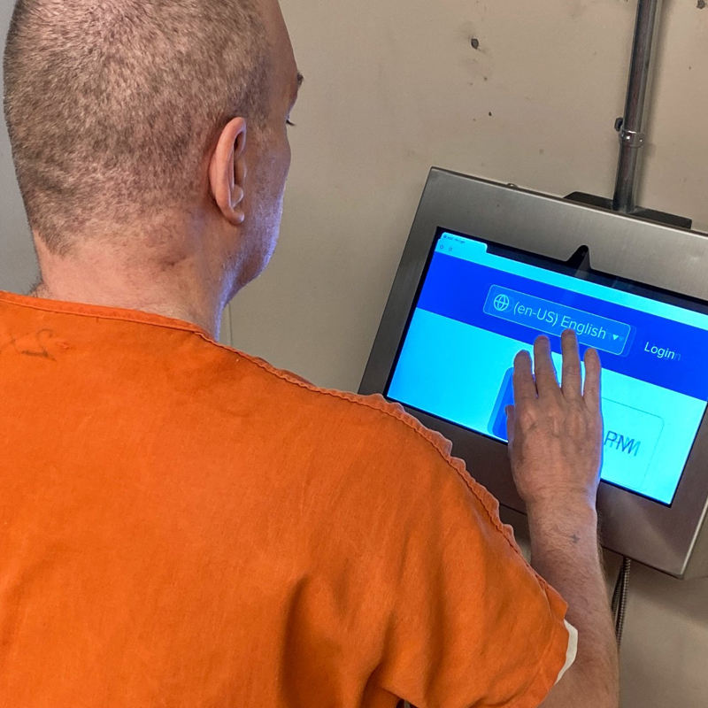 woman visiting an inmate on her phone